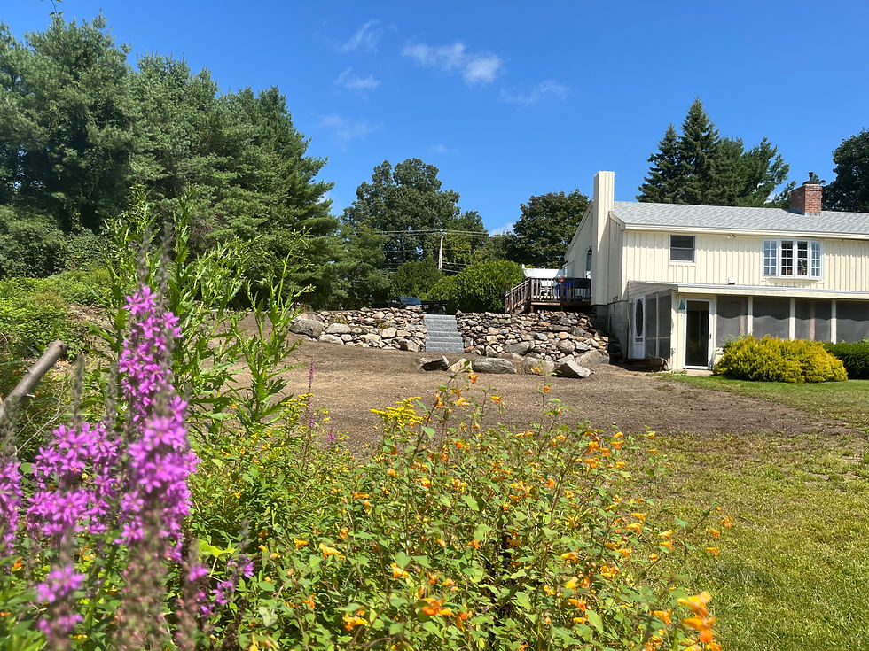 Boulder Retaining Wall with Granite Steps in Newmarket, New Hampshire.