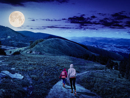 Laila and Shayla walking through a surreal blue mountain landscape beneath an oversized moon, a 2021 composite by Steph Kelly Photography.