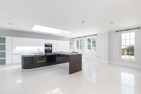 Contemporary luxury kitchen with central island and skylight