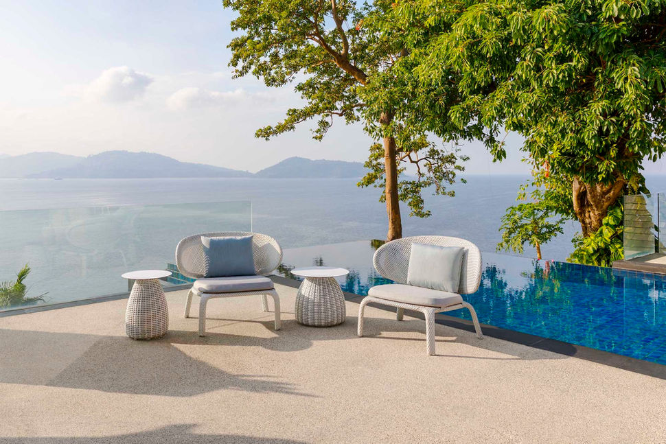 Oceanfront infinity pool with lounge seating and panoramic sea views in Phuket, Thailand