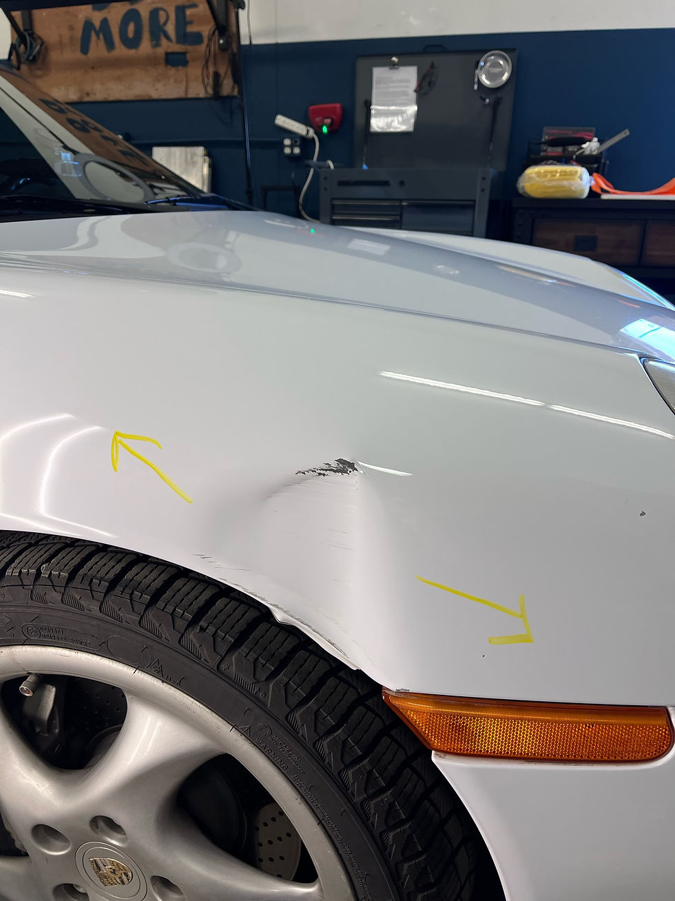 Eye-level view of a car being polished in a repair shop