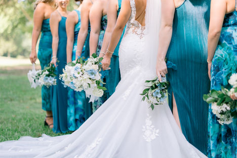 Bride and her bridesmaids in beautiful photo holding bouquets.