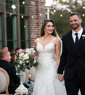 Bride and Groom Smiling and Walking Down Aisle in Lake Mary.