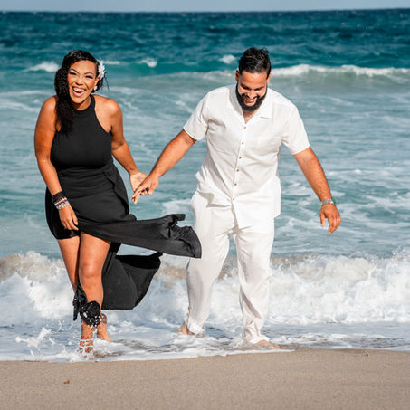 Couple having a fun photoshoot on the beach.