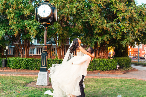 Couple enjoying their day in Rock Hill next to clock tower.