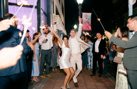 Happy couple jumping for joy as they make their sparkling exit in the Downtown Historic District in Rock Hill.