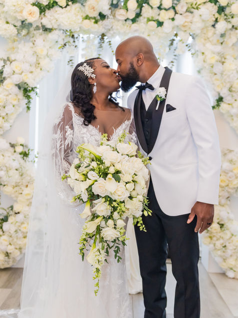 Latoya and William sharing an intimate moment under the ceremony arch at the Crystal Ballroom Rock Hill.