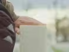 a hand resting on a grave