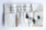Crumpled paper with handwritten text about seals from Friedrich Wilhelm I's coffin, found in 1945. Three metal seals are displayed.