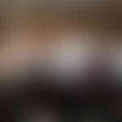 A man getting help putting his tux coat on