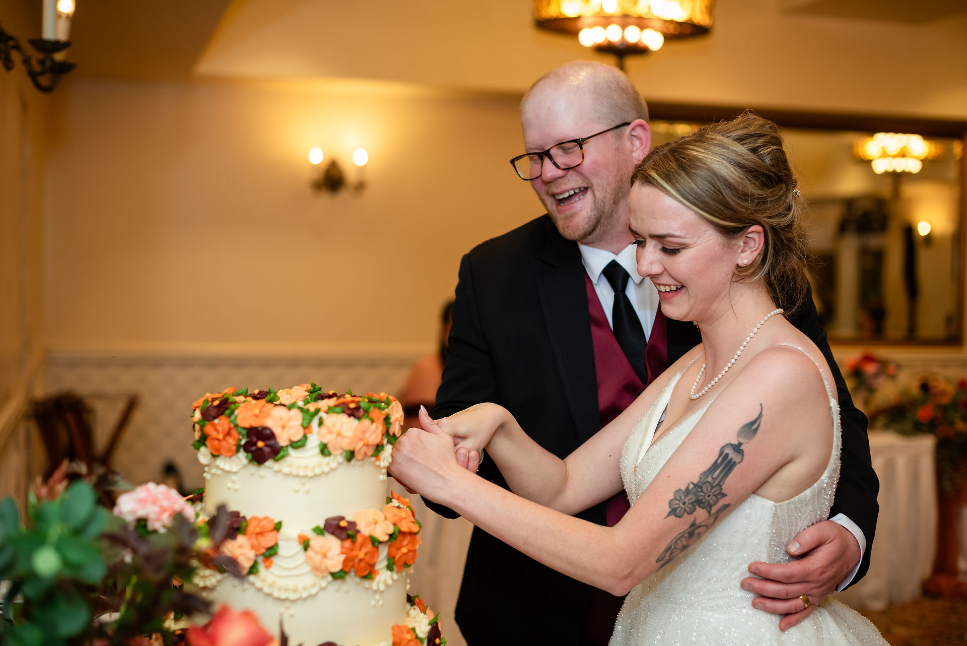Bride and groom cutting the cake at their reception. 