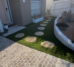 Paving, stepping stones, turf, retaining wall and planting