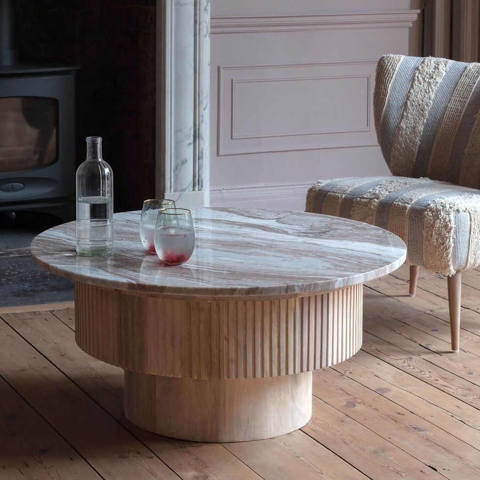 Round marble coffee table with armchair, glasses and bottle
