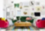 Victorian-style living room withwall prints and coloured armchairs
