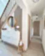 Modern hallway with mirror and stairs