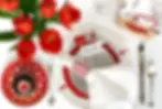 Table with red tulips, cupcake and romantic decorations