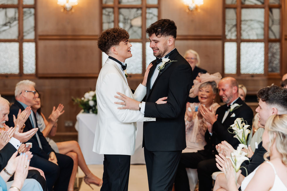 Two people embracing at a formal event.