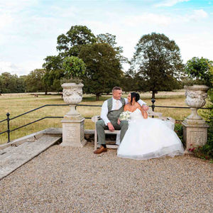 Happy lesbian couple sitting on bench, LUX Wedding Photos