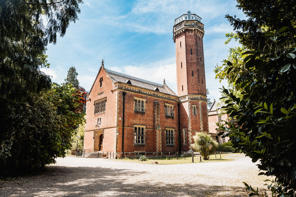 Historic brick building with a tall tower.