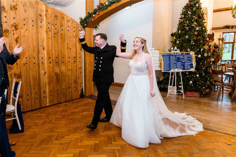 bride and groom cheering into room
