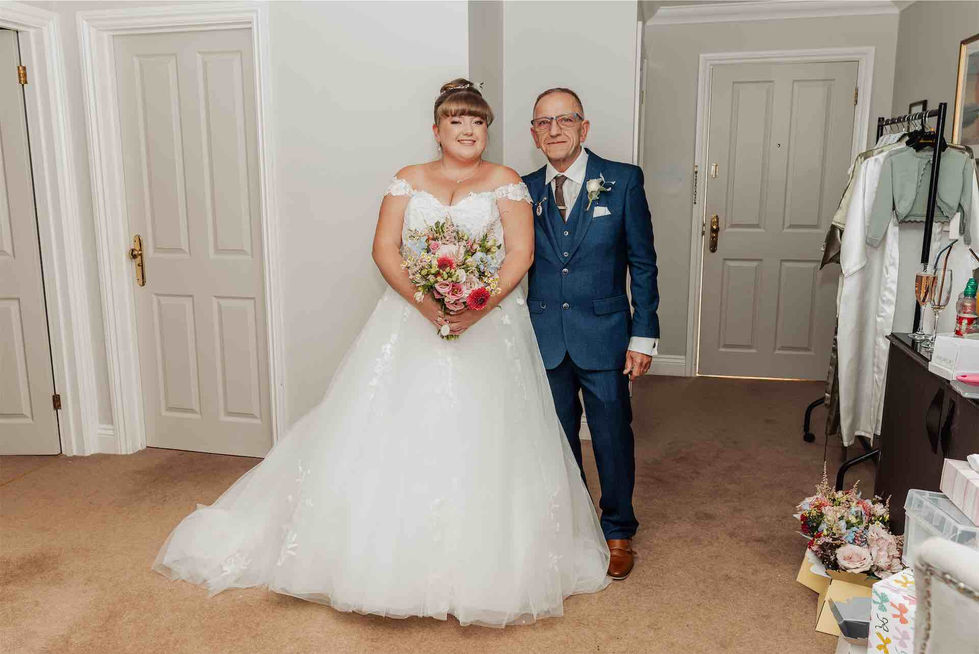 Bride and groom posing indoors, smiling together.