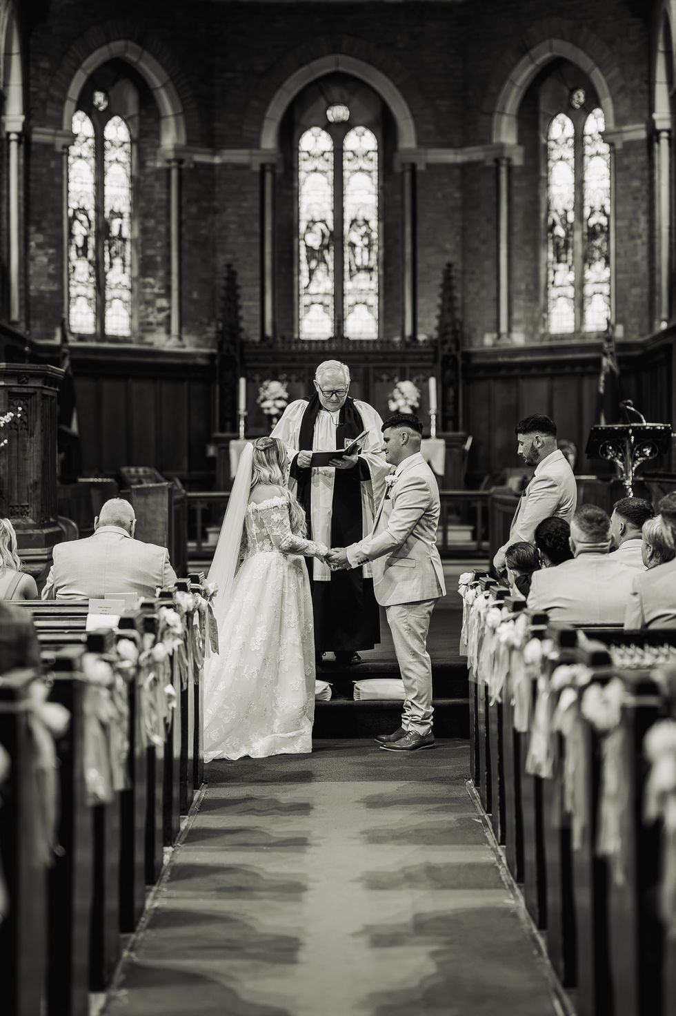 Bride and groom exchanging vows in a church.