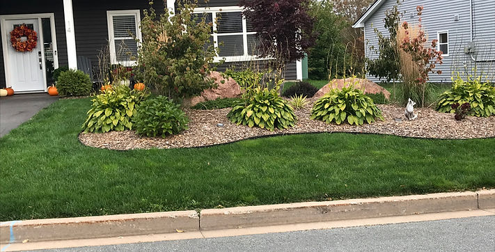 Completed garden revamp by Beautiful Lawns Halifax with fresh mulch, flowers, and trimmed edges