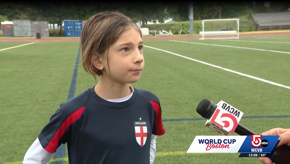 Boston youth soccer players escorting World Cup athletes onto the pitch