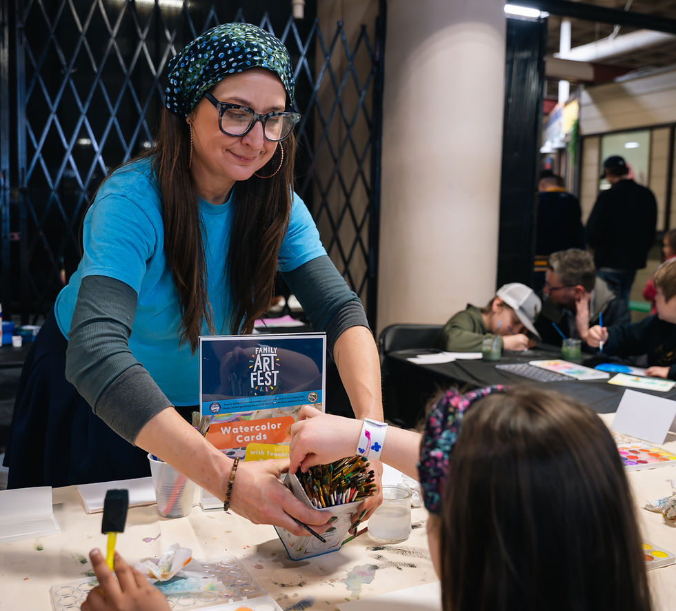 Teaching Artist Kristin Brandt leading a Watercolor Cards station at Family ArtFest 2026.