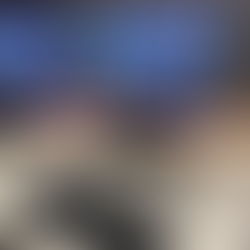 a screen showing a boy playing a video game. in front of the desktop screen is a pair of headphones