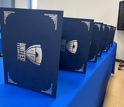 Diplomas await graduates of a United Technical Training Academy class