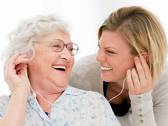 Elderly women listening to music with her caregiver in the comfort of her home in Minneaplis Minnesota in home senior care