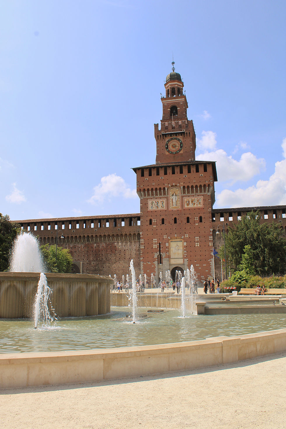 Castello Sforzesco and fountain outside main gate in Milan Italy