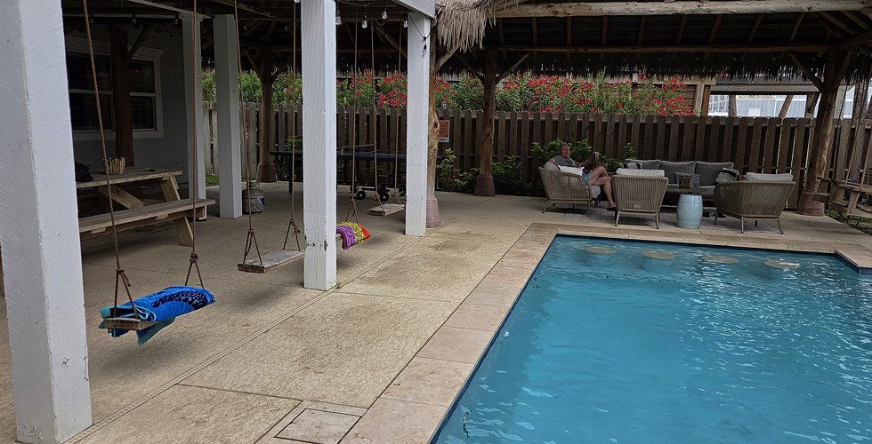 Another view of the pool area, cabana, and covered patio