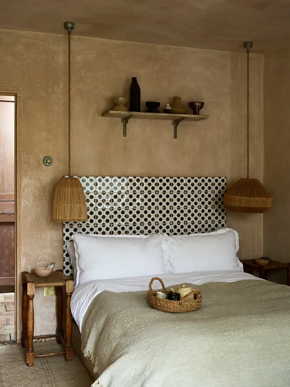 Zellige tiled headboard in neutral tones styled with linen bedding, rattan pendant light, and natural timber nightstands in a contemporary UK bedroom interior.