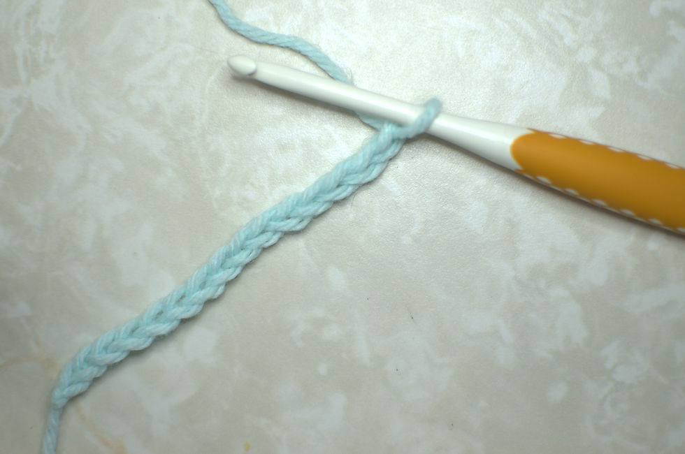 a crochet chain made with light blue yarn