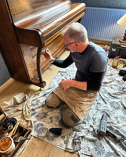 Owen restoring a piano