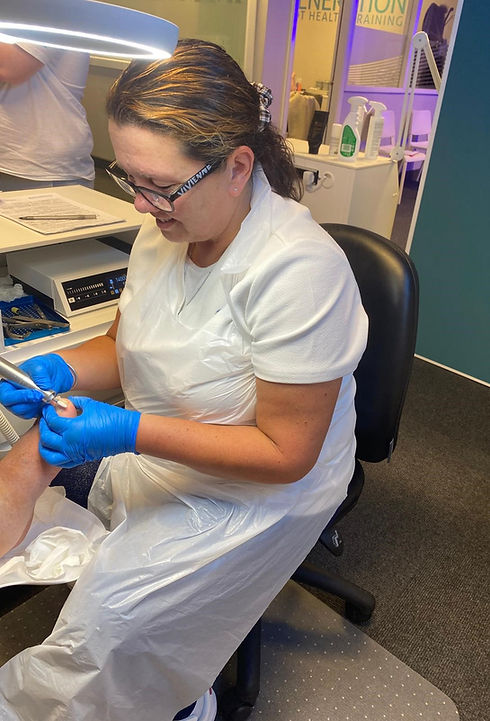 Photo of Pamela Brown, foot health practitioner, tending someone's foot