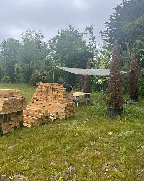 large pile of handmade fence posts and rails