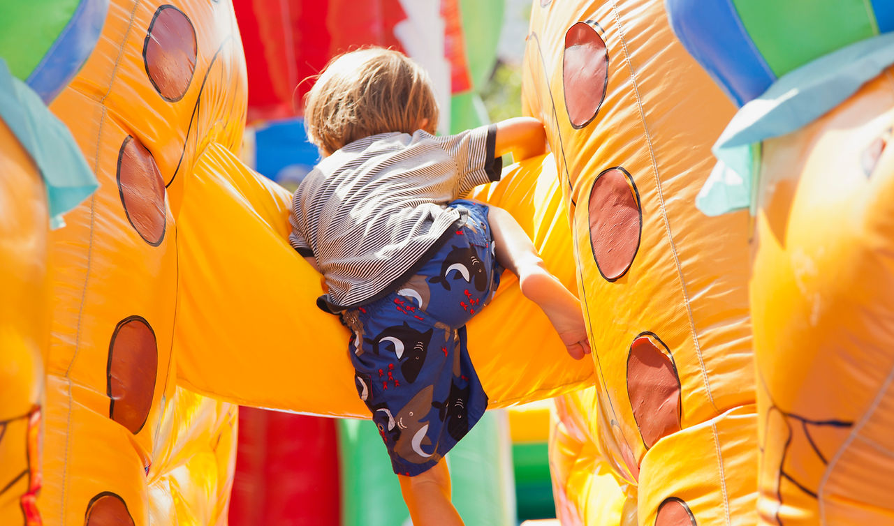 Boy Playing in Bouncy Castle