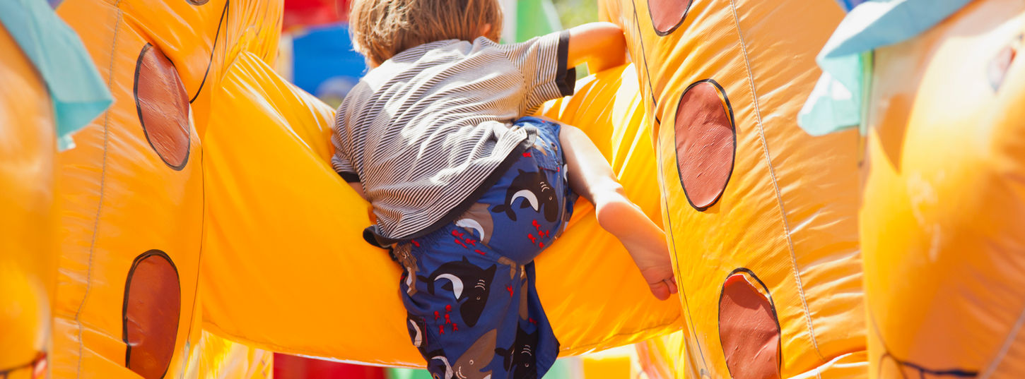 Boy Playing in Bouncy Castle