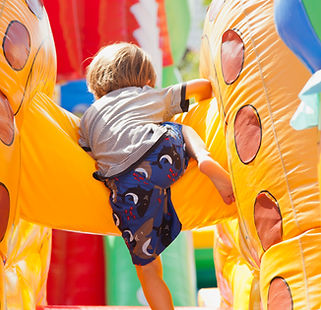 Boy Playing in Bouncy Castle