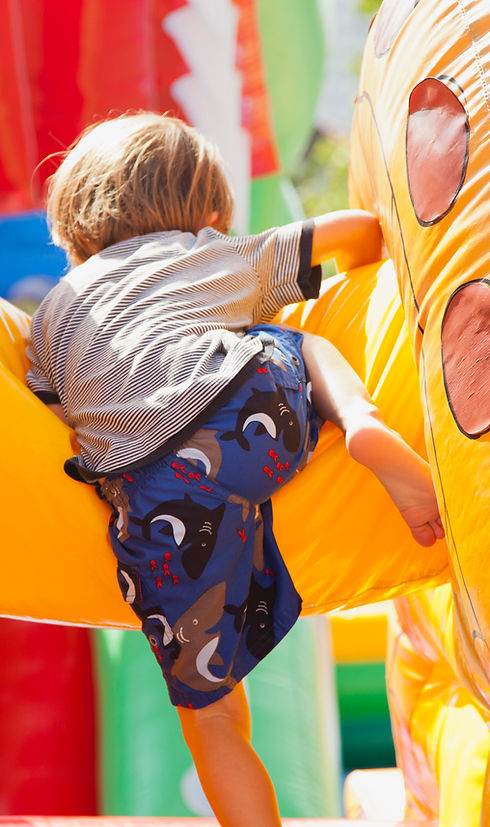 Boy Playing in Bouncy Castle