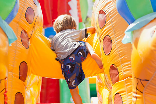 Boy Playing in Bouncy Castle