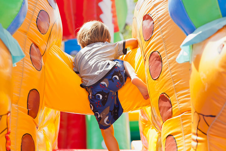 Boy Playing in Bouncy Castle
