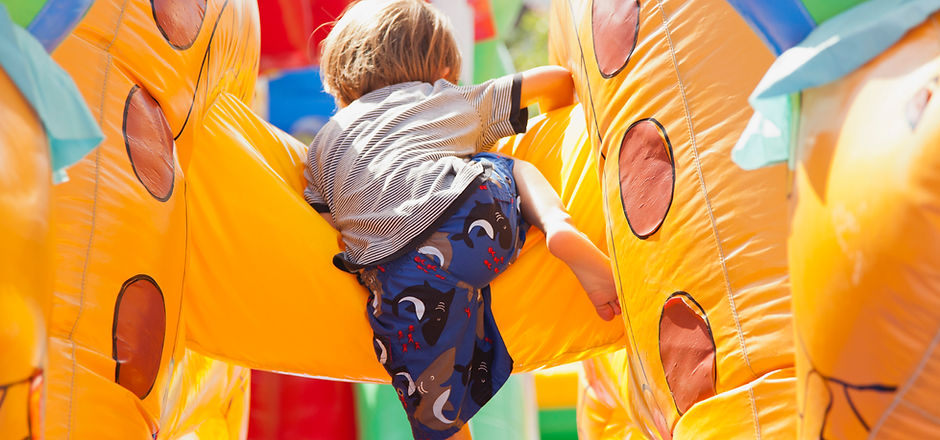 Boy Playing in Bouncy Castle