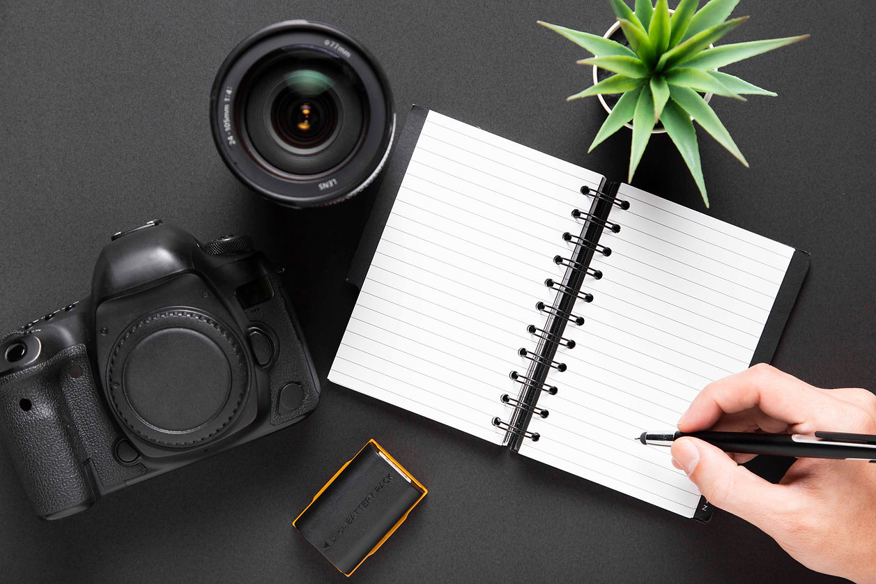flat-lay-camera-lenses-notebook-black-background.jpg