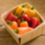 A small wooden box filled with Lunchbox Sweet Peppers.