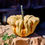 Miniatura: A Mac and Cheese pumpkin on a wooden stump.