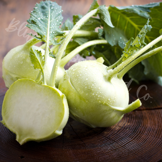 Fresh washed Early White Vienna kohlrabi sliced on a wooden table.
